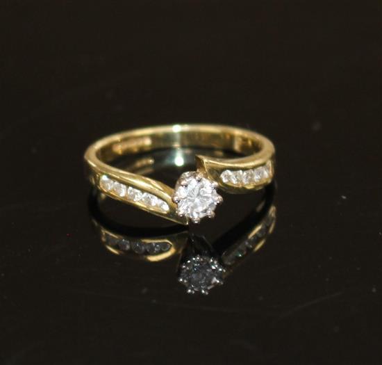 A modern 18ct gold and single stone diamond ring, with diamond set shoulders, size L/M, gross weight 3 grams.